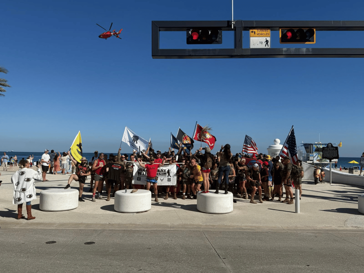 Rally Point veterans gathering at the beach with Coast Guard flyover